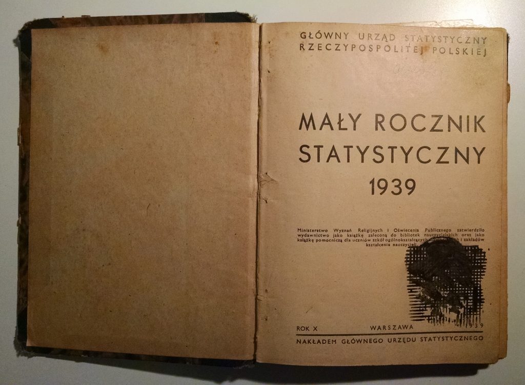 Title page of my grandfather's copy of the 1939 Concise Statistical Year-Book of Poland, with stamps and inked-out scribbles
